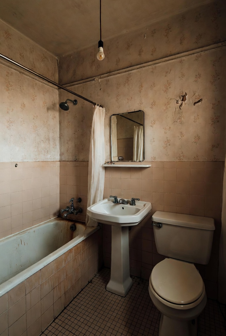 Bright marble-tiled bathroom with hexagonal floor tile and backlit mirror after HandyForce renovation